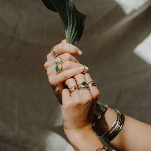 A girl wearing Leia Zumbro's handmade rings and holding a leaf